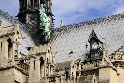 France, Paris, ile de la Cite, Notre-Dame Cathedral, one of the clocks and the spire dominates the statues of green copper of twelve apostles with the symbols of four evangelists