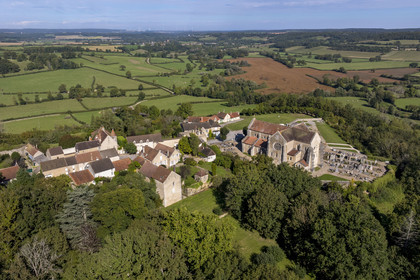 France, Yonne, Montreal (Burgundy), the 12th century Romanesque Notre-Dame collegiate church at the village top (aerial view)
