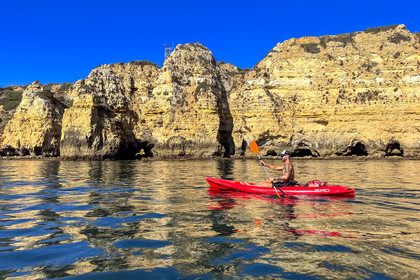 Portugal, Algarve, Lagos, Kayak tour at the foot of the steep cliffs of Ponta da Piedade