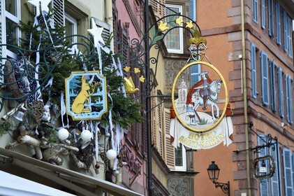 France, Haut Rhin, Colmar, traditional signs in the Grand Rue with Christmas decorations
