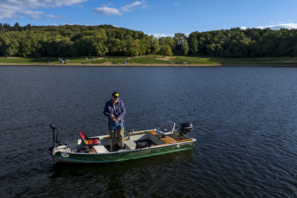 France, Nievre, Regional Natural Park of Morvan, Chaumard, Pannecière lake, Jean-Bernard Dioux, vice-president of the AMC, the Morvan Carnassier Association, fishing on a boat (aerial view)