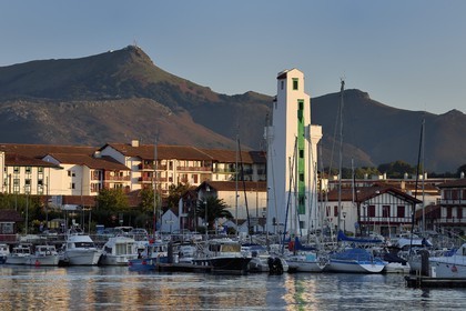 France, Pyrenees Atlantiques, Basque Country, Saint Jean de Luz, boat at the port and lighthouse of Ciboure built by André Pavlovsky in 1936, the summit of Larrun (La Rhune) mountain in the background