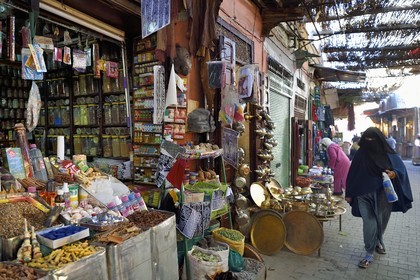 Morocco, High Atlas, Marrakech, Imperial city, Medina listed as World Heritage by UNESCO, spice seller in the souk and veiled woman