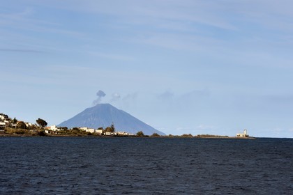 Italie, Sicile, iles Eoliennes, classées Patrimoine Mondial de l'UNESCO, phare du village de Lingua sur l'Ile de Salina, le volcan Stromboli en arrière plan