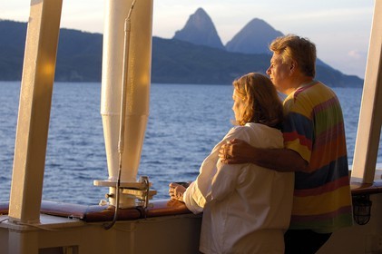 Caribbean sea, Saint Lucia island, couple of lovers aboard the Royal Clipper looking towards the Piton (of Soufriere)