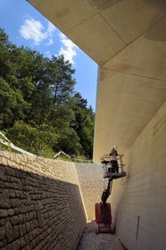 France, Dordogne, Montignac, Montignac-Lascaux Parietal Art international Centre (Lascaux 4) building site designed by the Norwegian architectural agency Snøhetta, access to the reconstitution of the cave by a long sloping trench at the edge of forest and made of concrete and local stones