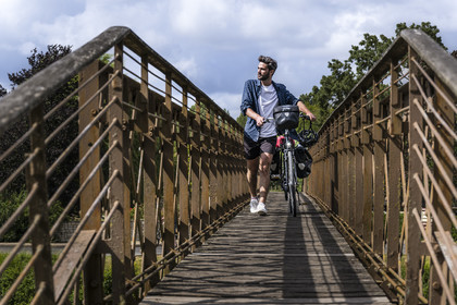 France, Deux-Sèvres, le Marais Poitevin, Green Venice, Le Mazeau, bicycle journey along the Sevre Niortaise River banks and crossing a footbridge