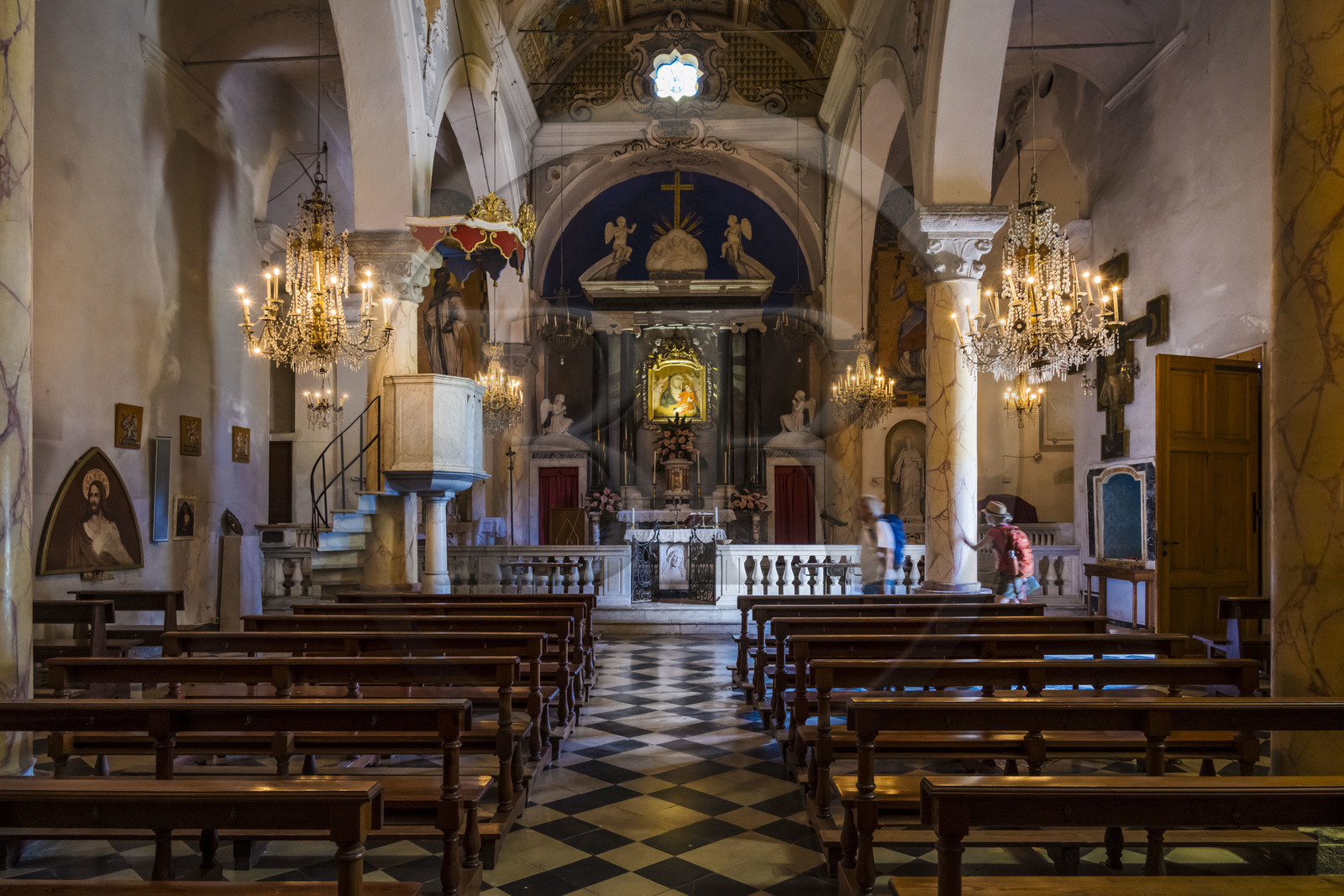 Italy, Liguria, Cinque Terre National Park listed as World Heritage by UNESCO, hikers in the church of the sanctuary of Nostra Signora di Reggio on the heights of the village of Vernazza