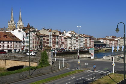 France, Pyrenees Atlantiques, Basque Country, Bayonne, the Nive river banks, the spires of St. Catherine's Cathedral behind the Jaureguiberry wharf and the covered market les Halles