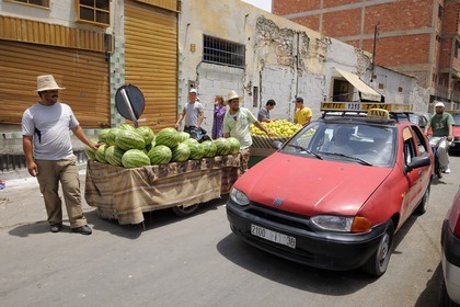Morocco, Oriental Region, Oujda, watermelon sellers and small taxi