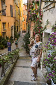 France, Alpes-Maritimes, Nice, listed as World Heritage by UNESCO, Old Nice, Marie-Odile Martin who belongs to the brotherhood of the Red Penitents meets her friend Jean Jacques Wannere who greens the rue de l'Ancien Sénat