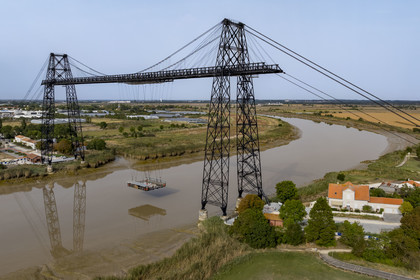 France, Charente Maritime, Rochefort, the Rochefort (or Martrou) transporter bridge built by Ferdinand Arnodin in 1900, the nacelle is in translation above the Charente river (aerial view)