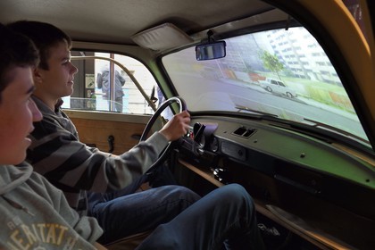 Germany, Berlin, DDR Museum, a museum opened in 2006 to recall the everyday life of former East Germany, teenagers driving virtually a Trabant