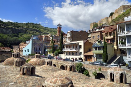 Géorgie, Tbilissi, vieille ville, quartier thermal de Abanotoubani avec les toits des bains sulfureux publiques, les Bains Orbeliani à la façade carrelée bleue, le minaret de la mosquée et la forteresse de Narikala (IVème siècle) en arrière plan