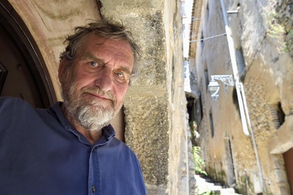 France, Alpes-Maritimes, Saint Paul de Vence, Olivier Kaeppelin President of the International Biennale of Saint-Paul de Vence in the rue du Casse Cou