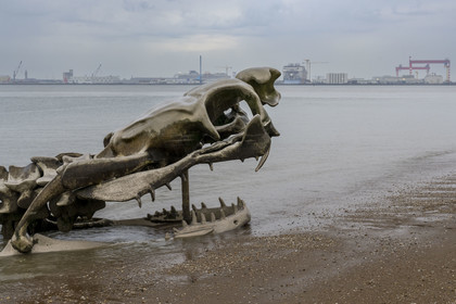 France, Loire Atlantique, Saint-Brevin-les-Pins, Mindin, Estuaire (Estuary) open-air contemporary art collection, the Ocean Serpent created by the Chinese artist Huang Yong Ping representing a long skeleton of a sea serpent, installed on the 'foreshore and appearing to the rhythm of the tides, the port of Saint-Nazaire in the background