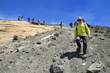 Italy, Sicily, Aeolian Islands, listed as World Heritage by UNESCO, Vulcano Island, hikers descending the crater flanks of volcano della Fossa