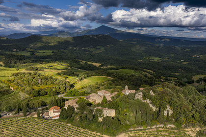 France, Vaucluse, Dentelles de Montmirail mountains, the village of Suzette surrounded by vineyards and the Mont Ventoux in the background (aerial view)