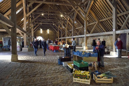 France, Calvados, Pays d'Auge, Saint Pierre sur Dives, sale of fruits and vegetables under the 11th century covered market rebuilt in the 15th century