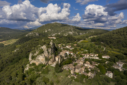 France, Vaucluse, Dentelles de Montmirail mountains, the hilltop village of La Roque-Alric and Mont Ventoux in the background (aerial view)