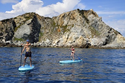France, Var, Six Fours les Plages, Ile des Embiez, Pointe du Coucoussa overlooked by the Tour de la Marine, Freestyle windsurfing champion Adrien Bosson on a paddle boarding excursion