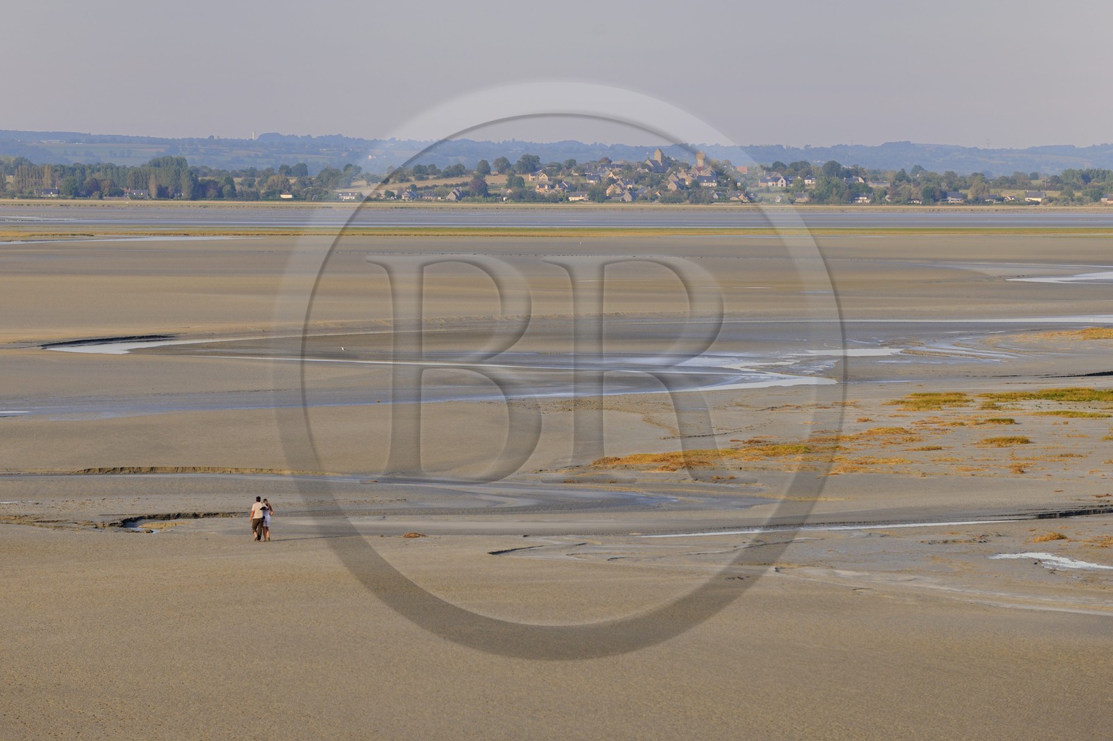 France, Manche, crossing by walking of the Bay of Mont Saint Michel at low tide and the village of Saint Leonard