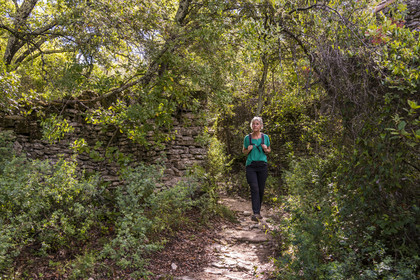 France, Gard, Uzès, hiker on a path along the scrubland along the route of the Roman aqueduct of Nimes