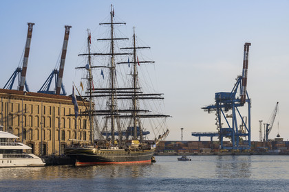 Italy, Liguria, Genoa, the Porto Antico (Old Port), the three-mast clipper Stad Amsterdam alongside and the commercial port in the background