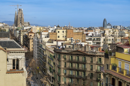 Spain, Catalonia, Barcelona, Eixample district, the Sagrada Familia under construction and the Torre Agbar (Agbar Tower) by architect Jean Nouvel in the background