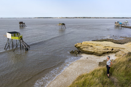 France, Charente Maritime, Port des Barques, Ile Madame, huts on stilts called carrelets and cyclist on a hike (aerial view)