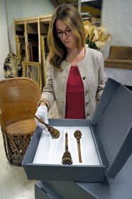 France, Alpes de Haute Provence, Ubaye valley, Barcelonnette, mexican villa known as Villa Sapiniere, Valley Museum, the curator Helene Homps in the museum reserve presenting a molinillo (traditional Mexican turned wood whisk)  that served in particular to prepare hot chocolate and brought back as souvenirs by many Barcelonnettes