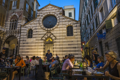 Italy, Liguria, Genoa, alley of the old historic center, restaurant terrace in Piazza San Matteo