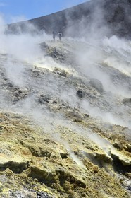Italy, Sicily, Aeolian Islands, listed as World Heritage by UNESCO, Vulcano Island, hikers climbing the crater of volcano della Fossa through sulfur fumaroles