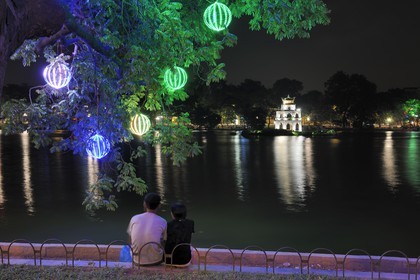 Vietnam, Hanoi, old town, Hoan Kiem Lake also called the small lake or Lake of the Restored Sword, couple of lovers facing the Turtle tower (Thap Rua)