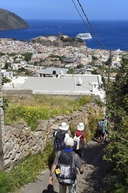 Italy, Sicily, Aeolian Islands, listed as World Heritage by UNESCO, Lipari Island, hikers descending to the town of Lipari