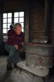 France, Vosges, Ballons des Vosges Regional Natural Park, Saint Maurice sur Moselle, the chalet des cretes, a log shelter built by foresters and open to hikers who can warm themselves around the stove, Robert Jacquot President of the Remiremont section of the club vosgien