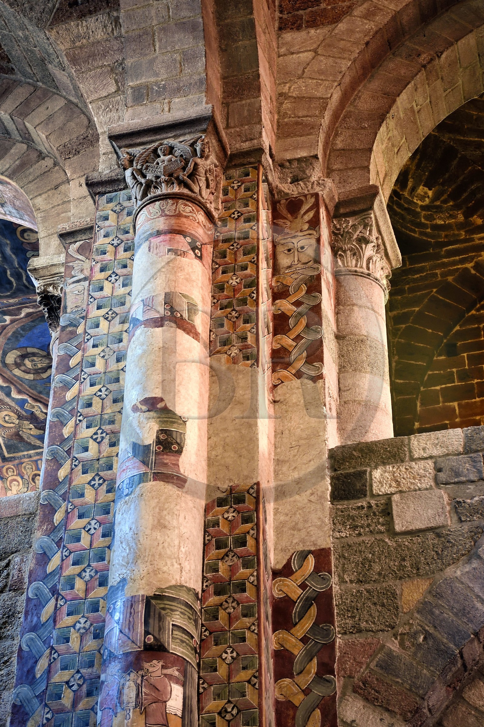 France, Haute Loire, Brioude, the Basilica of Saint-Julien de Brioude in Auvergne Romanesque style, pillars of the front nave surmounted by capitals decorated with motifs and covered with frescoes
