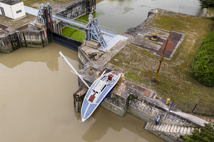 France, Loire Atlantique, Le Pellerin, open-air contemporary art collection Estuary, the 9 m long sailboat sculpture Misconceivable created by the Austrian artist Erwin Wurm at the access lock to the Martinière canal on the Loire river (aerial view)