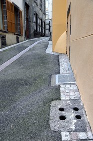 France, Puy de Dome, Clermont Ferrand, stone with holes at the exit of an aeration well of a tuff underground gallerie