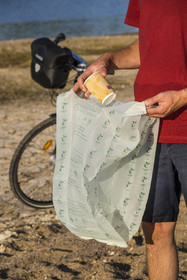 France, Maine-et-Loire, Loire valley listed as World Heritage by UNESCO, Saumur towards Saint-Hilaire, cycling along the banks of the Loire, camping for the night on one of the sandbanks forming islands on the Loire, bin bag for organic waste