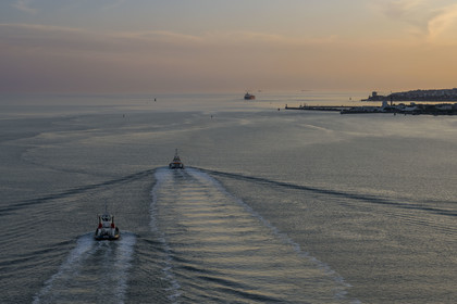 France, Loire Atlantique, Estuaire de la Loire, Saint Nazaire, port tugs going to join a ship