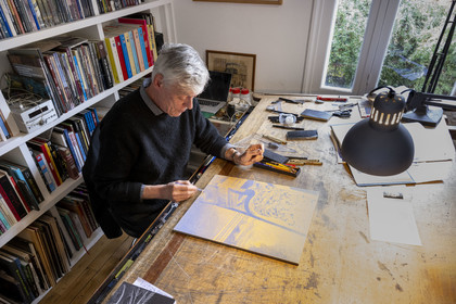 France, Paris, cartoonist and comic book author François Schuiten in his Parisian studio, He is making adjustments to his drawing on one of the future ceramic plaques that will adorn the platform of the Pont de Sèvres metro station on the future Grand Paris Express network.
