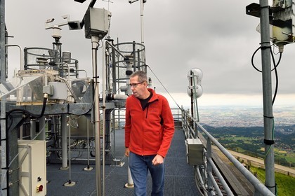 France, Puy de Dome, Parc Naturel Régional des Volcans d'Auvergne, Observation station at the top of Puy du Dôme, Jean-Luc Baray researcher at the Laboratory of Physical Meteorology (Clermont-Ferrand Earth Physics Observatory (OPGC) and Blaise Pascal University in Clermont-Ferrand), reads weather data from sensors on the roof of the institute and controls the measured meteorological and microphysical parameters (in particular the number and size of water drops)