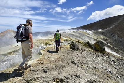 Italy, Sicily, Aeolian Islands, listed as World Heritage by UNESCO, Vulcano Island, hikers climbing the crater of volcano della Fossa through sulfur fumaroles
