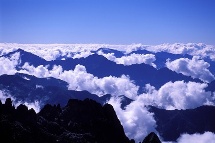 France, Haute Corse, Corsican Mountains appearing from Clouds (Aerial View)