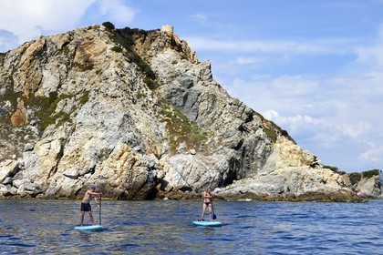 France, Var, Six Fours les Plages, Ile des Embiez, Pointe du Coucoussa overlooked by the Tour de la Marine, Freestyle windsurfing champion Adrien Bosson on a paddle boarding excursion