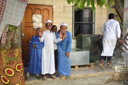 France, Mayotte island (French overseas department), Grande-Terre, Sada, children wearing an embroidered kofia, traditional Comoran hat, coming out of the madrassa