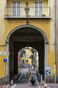 France, Alpes-Maritimes, Nice, listed as World Heritage by UNESCO, Old Nice, Virginie Acchiardo, chef of the restaurant Chez Acchiardo, walks her dog in rue Guigonis