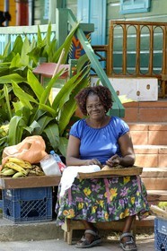 Caribbean sea, Barbados island, women in front of her house in Mango bay village close to Holetown