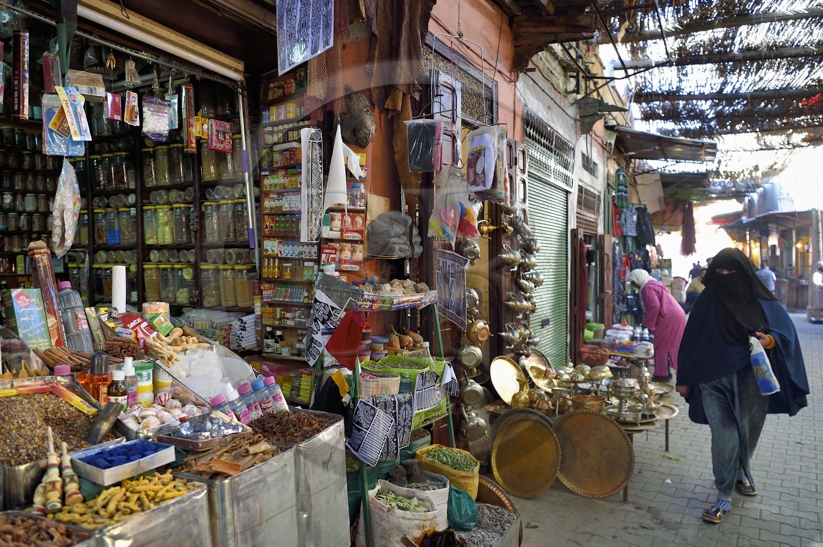 Morocco, High Atlas, Marrakech, Imperial city, Medina listed as World Heritage by UNESCO, spice seller in the souk and veiled woman